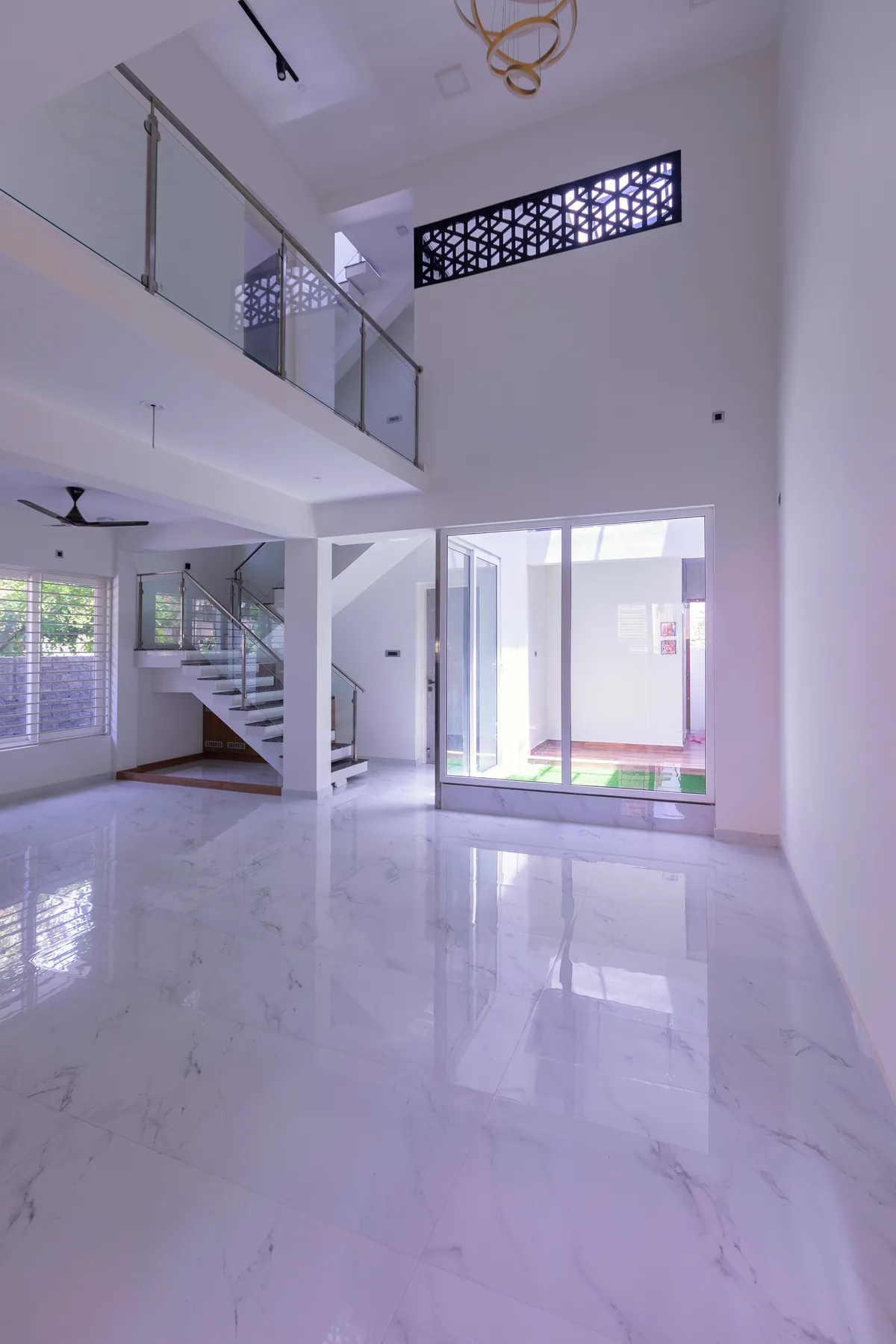 Karthick Residence — double-height living room with jaali screen, Guduvanchery, Chennai